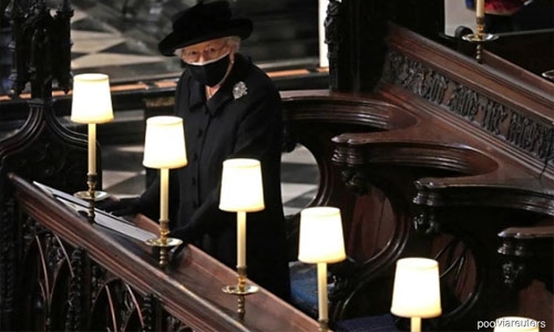 Queen Elizabeth stands alone as Philip is laid to rest; William and Harry talk