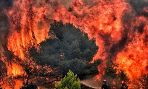Fire west of Athens still burning but crews manage to save village