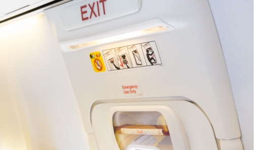 Man arrested after attempting to open emergency exit twice on Sydney-bound flight