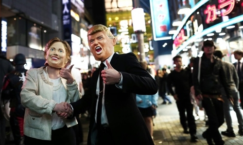 Clinton embraces Trump in grisly Japan Halloween