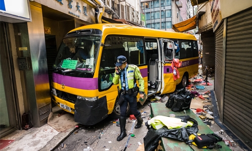 Four killed as Hong Kong schoolbus mounts pavement