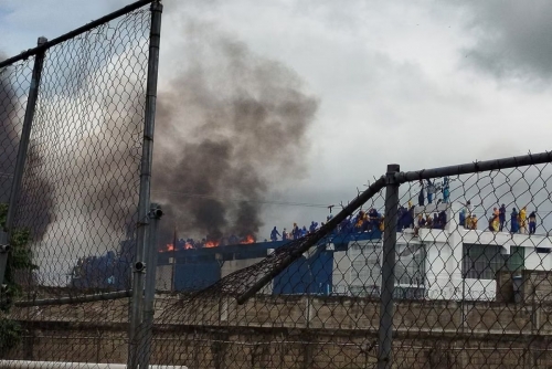 Venezuela inmates occupy prison roof and set fire to mattresses to protest alleged abuses