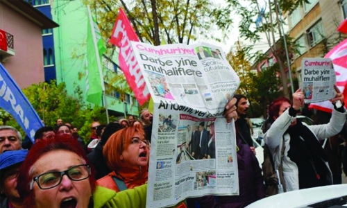 Turkish court jails nine staff of opposition daily