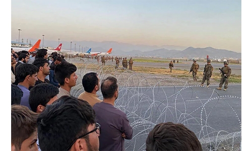 US troops fire shots in air at Kabul airport as crowd mobs tarmac, says official US troops fire shots in air at Kabul airport as crowd mobs tarmac, says official