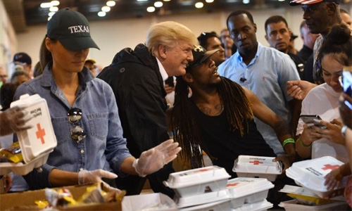 Trump visits evacuees at shelter in storm-battered Houston
