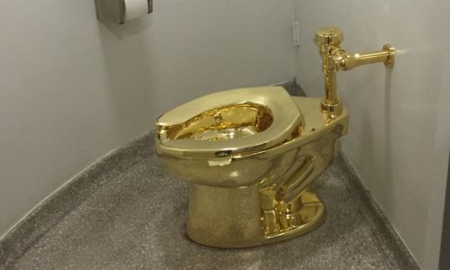 Four appear in UK court over theft of solid gold toilet from UK show