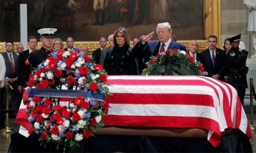 Bush remains lie in state as tributes pour in