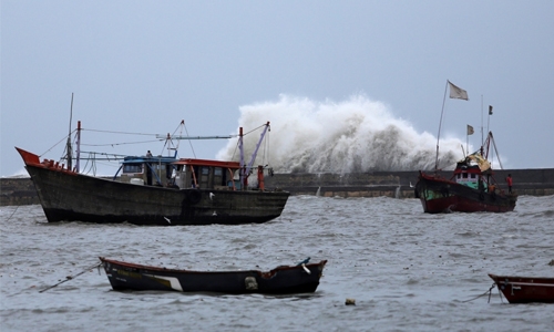 Winds, rain batter western India as cyclone veers away