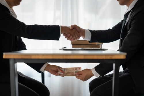 Bribes to Fast-Track Transactions: Employee, Businessman Face Trial 