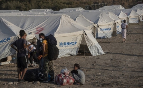 Migrants move into tents after fire guts Greek camp