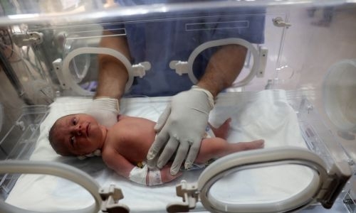 Newborn saved fromdead mother's womb in Gaza Newborn saved fromdead mother's womb in Gaza