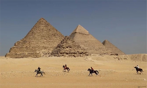 Egypt says probes images of naked couple atop pyramid