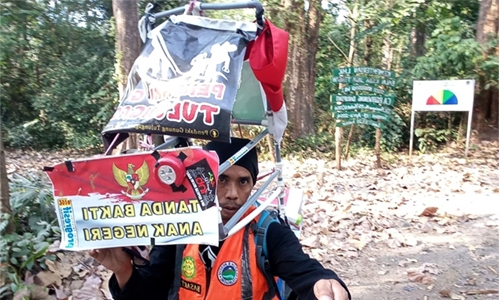 Man walking in reverse to save forests