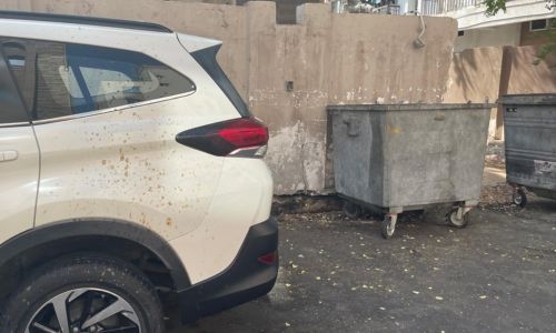 Um Al Hassam residents question irony of garbage trucks leaving dirt and debris on parked cars