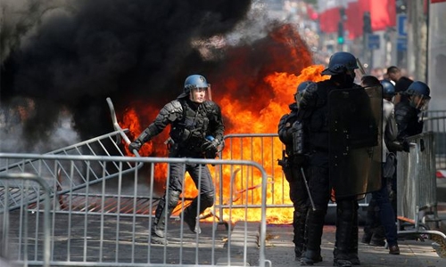 Paris clashes follow Macron’s military parade