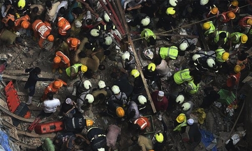 Woman rescued as death toll rises in building collapse