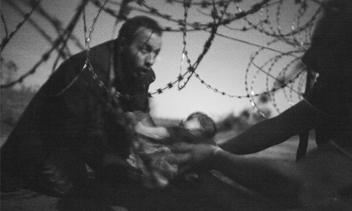 Image of baby at barbed wire fence wins World Press Photo