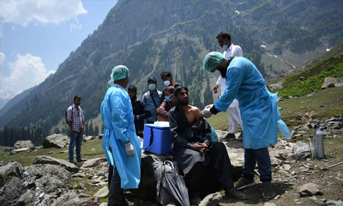 Indian medical workers scale mountains to bring vaccines to remote corners
