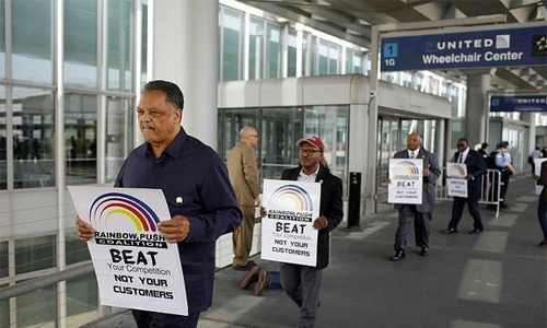 Man dragged off  flight to sue United