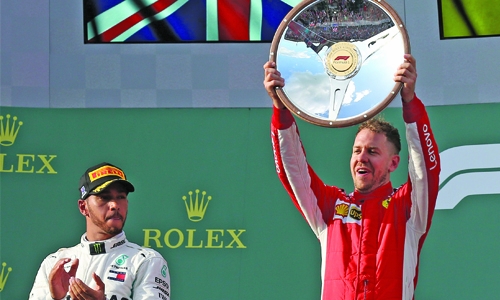 Vettel steals victory from Hamilton
