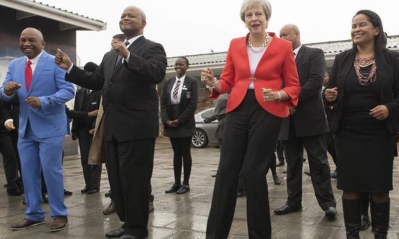 Britain’s May dances with children in South Africa